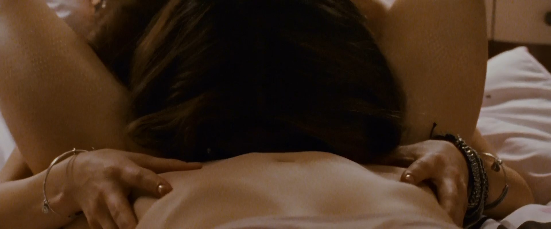 Natalie Portman and Mila Kunis making out passionately as they undress in a bedroom